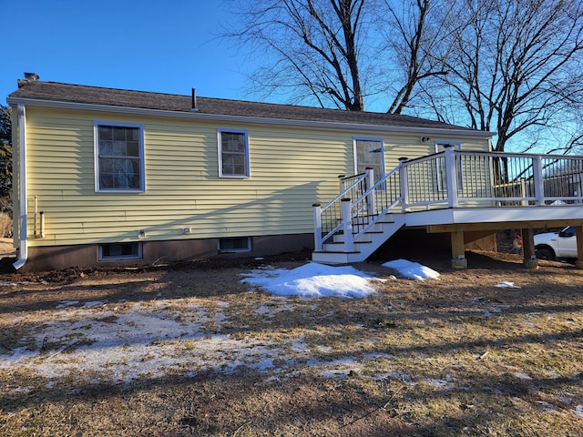 rear view of house featuring a wooden deck