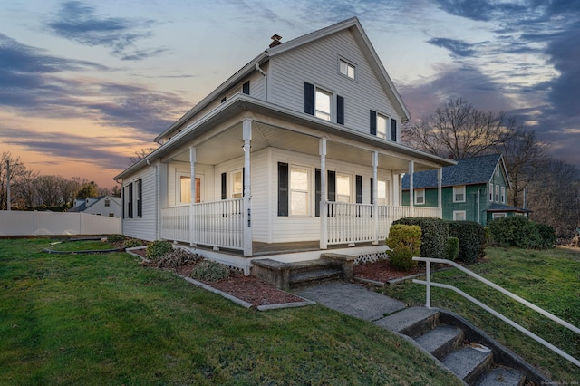 view of front facade featuring a lawn and a porch