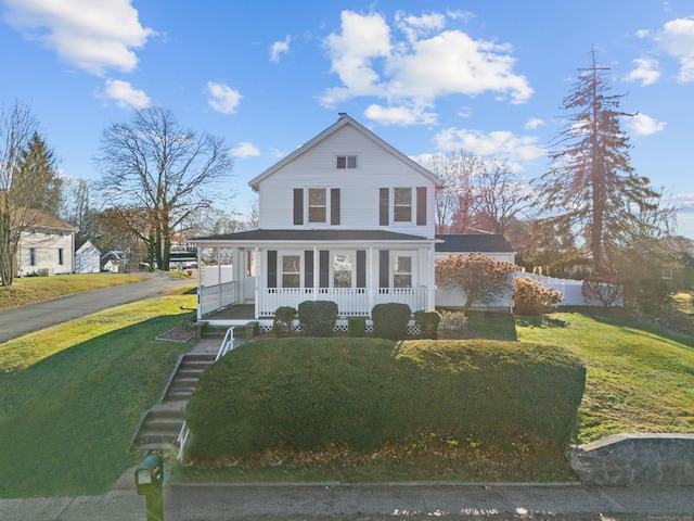 view of front of property with covered porch and a front yard