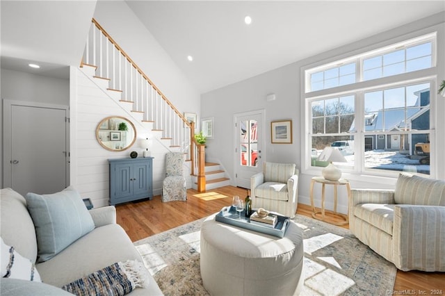 living room with hardwood / wood-style flooring and high vaulted ceiling