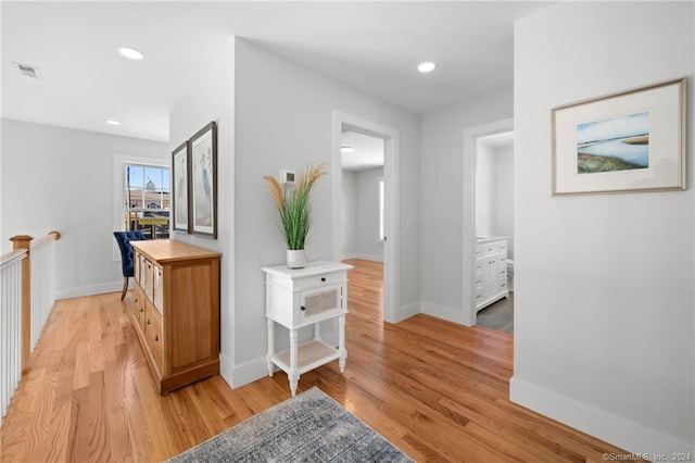 corridor with light hardwood / wood-style flooring