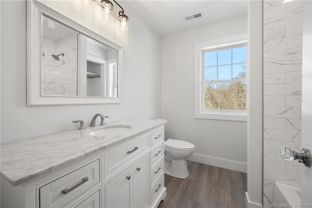 full bathroom featuring vanity, hardwood / wood-style floors, bathing tub / shower combination, and toilet