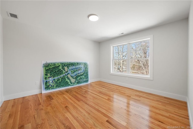 spare room with hardwood / wood-style floors