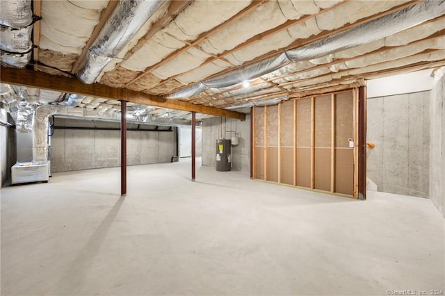 basement featuring heating unit and electric water heater