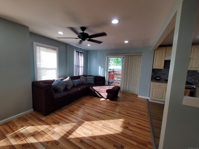 living room with ceiling fan, light hardwood / wood-style floors, and a healthy amount of sunlight