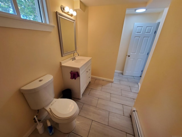 bathroom featuring vanity, a baseboard radiator, and toilet