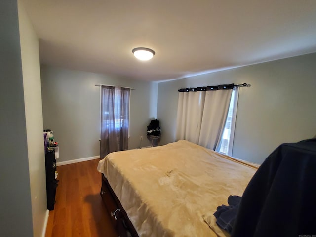 bedroom with dark hardwood / wood-style floors