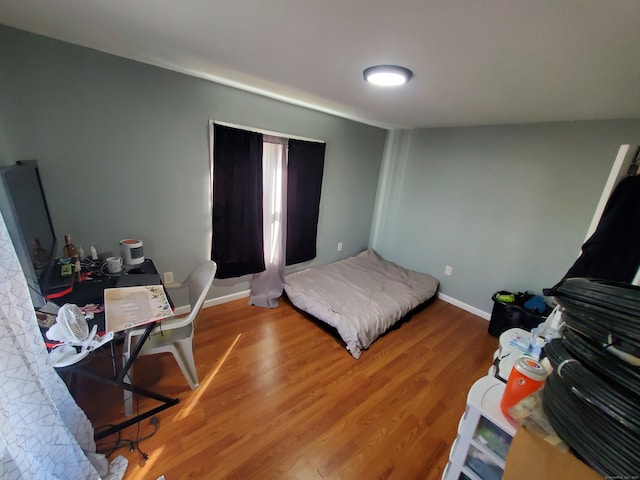 bedroom with wood-type flooring