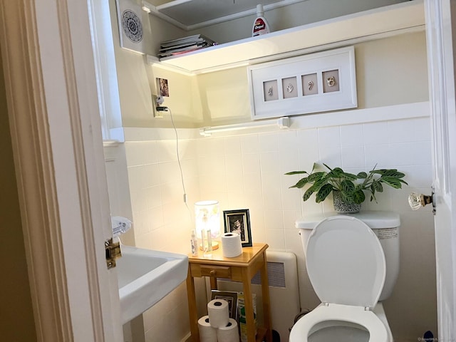 24 Brewster St, Stratford, CT 06614 - bathroom featuring tile walls and radiator heating unit