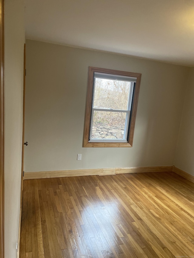 spare room with light hardwood / wood-style flooring