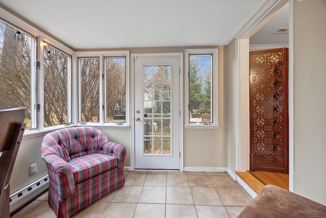 sunroom featuring a wealth of natural light and baseboard heating