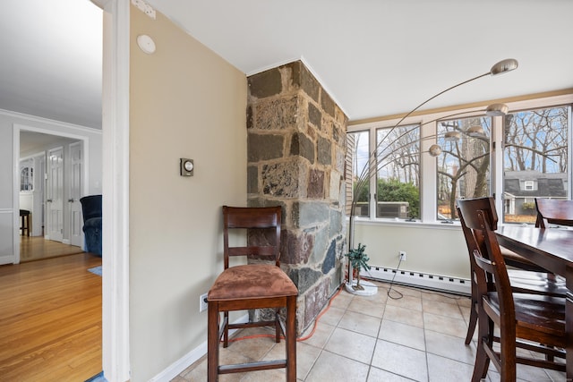 interior space with crown molding, light hardwood / wood-style flooring, and a baseboard heating unit