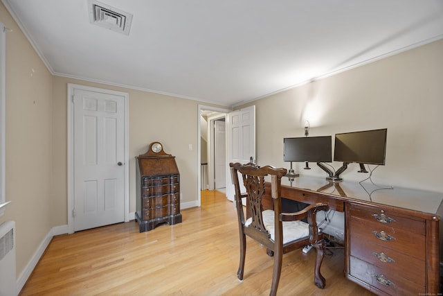 home office with light wood-type flooring and crown molding