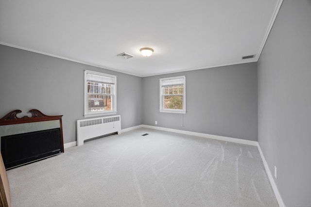 unfurnished room featuring light colored carpet, ornamental molding, and radiator