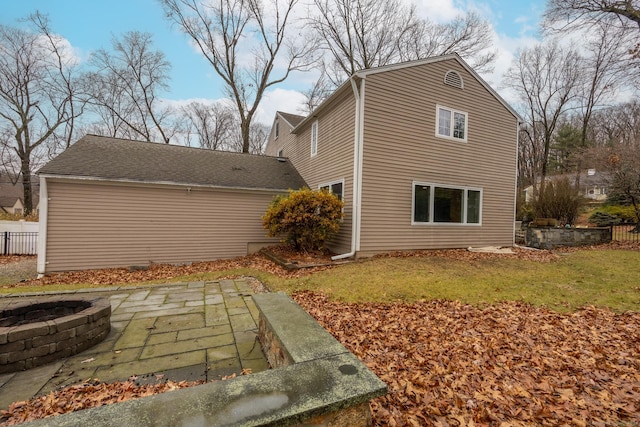 view of side of property featuring a patio area and a yard