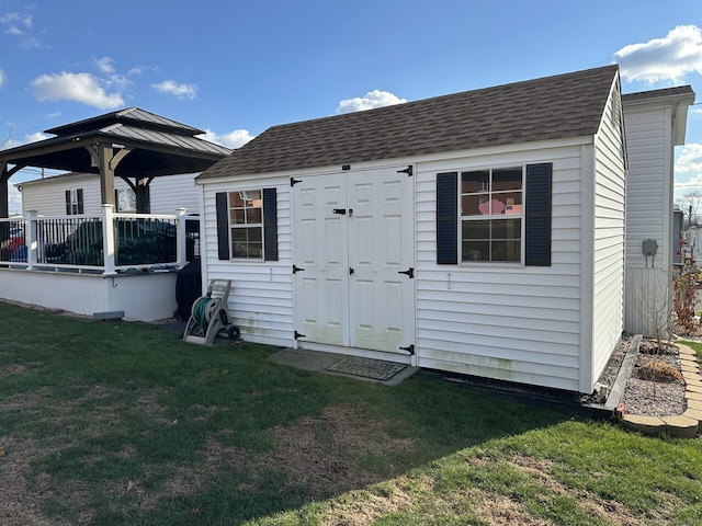 view of outbuilding with a yard and a gazebo