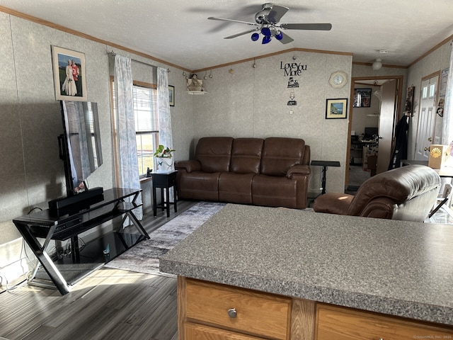 living room featuring ornamental molding, ceiling fan, dark hardwood / wood-style floors, a textured ceiling, and lofted ceiling