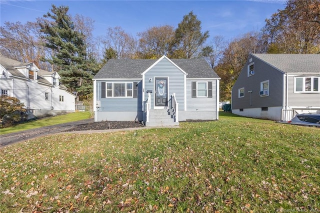 view of front of home featuring a front yard and roof with shingles