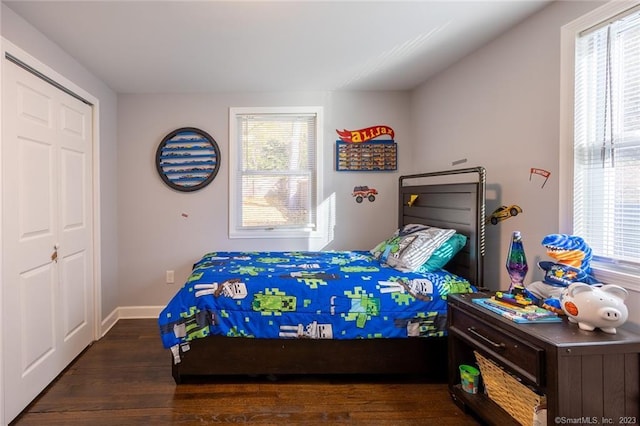 bedroom with wood finished floors and baseboards