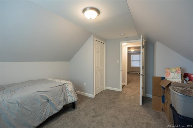 bedroom featuring carpet, a baseboard heating unit, vaulted ceiling, and baseboards