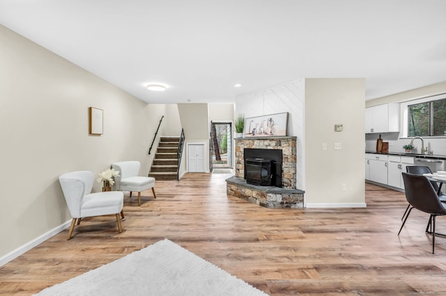 living room featuring light hardwood / wood-style floors and sink