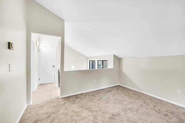 bonus room with light colored carpet and lofted ceiling