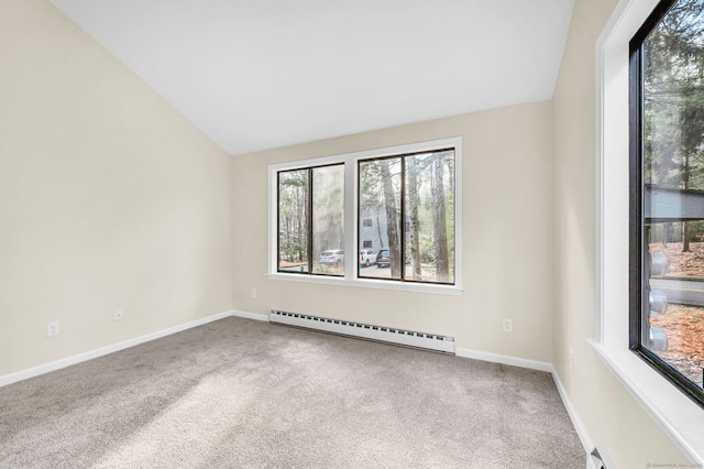 empty room featuring lofted ceiling, baseboard heating, a wealth of natural light, and carpet floors