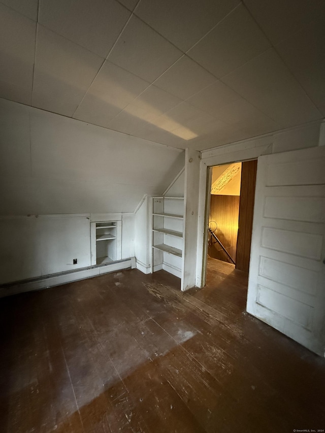 additional living space with a baseboard radiator and lofted ceiling