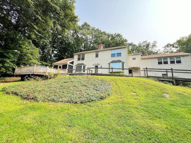 back of house with a yard and a deck