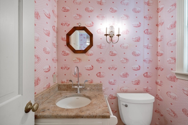 bathroom featuring vanity and toilet