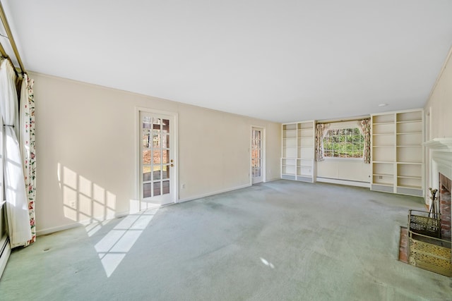 unfurnished living room featuring light carpet and a wealth of natural light