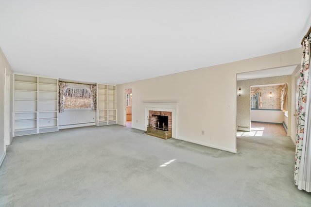 unfurnished living room with light colored carpet, a brick fireplace, and a baseboard heating unit