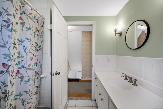 bathroom featuring tile patterned flooring, vanity, and curtained shower