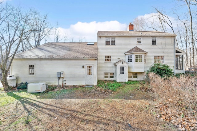 rear view of house with a yard