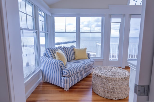 sunroom / solarium with a water view and a healthy amount of sunlight