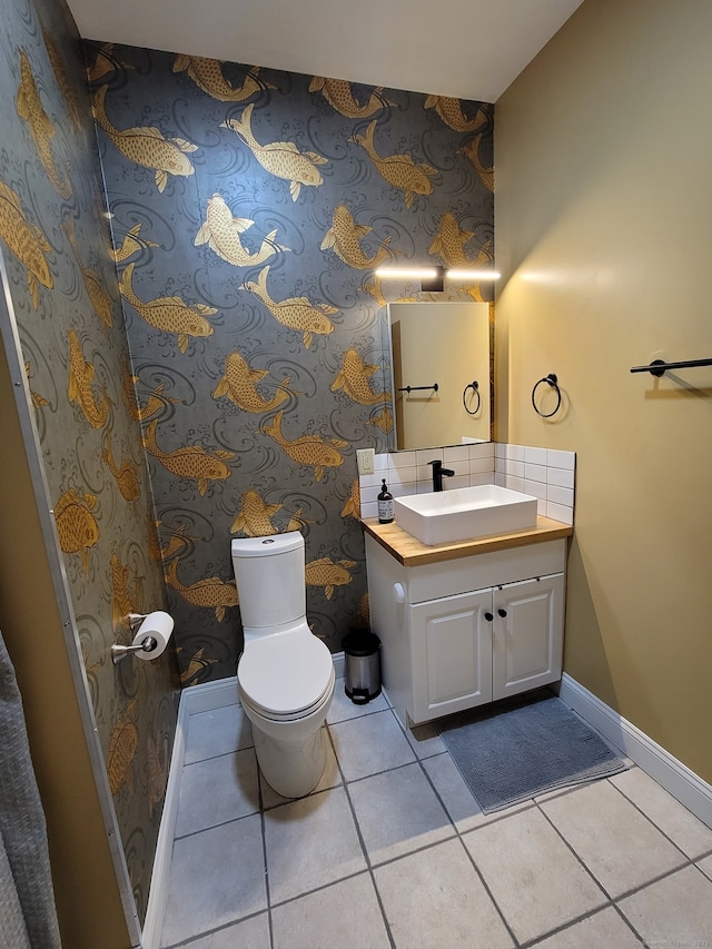 bathroom featuring vanity, tile patterned floors, and toilet