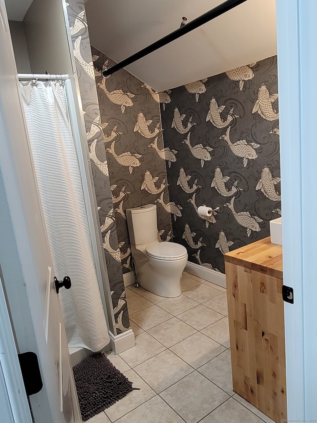 bathroom with tile patterned floors and toilet