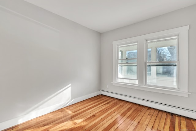 empty room featuring light hardwood / wood-style flooring and baseboard heating