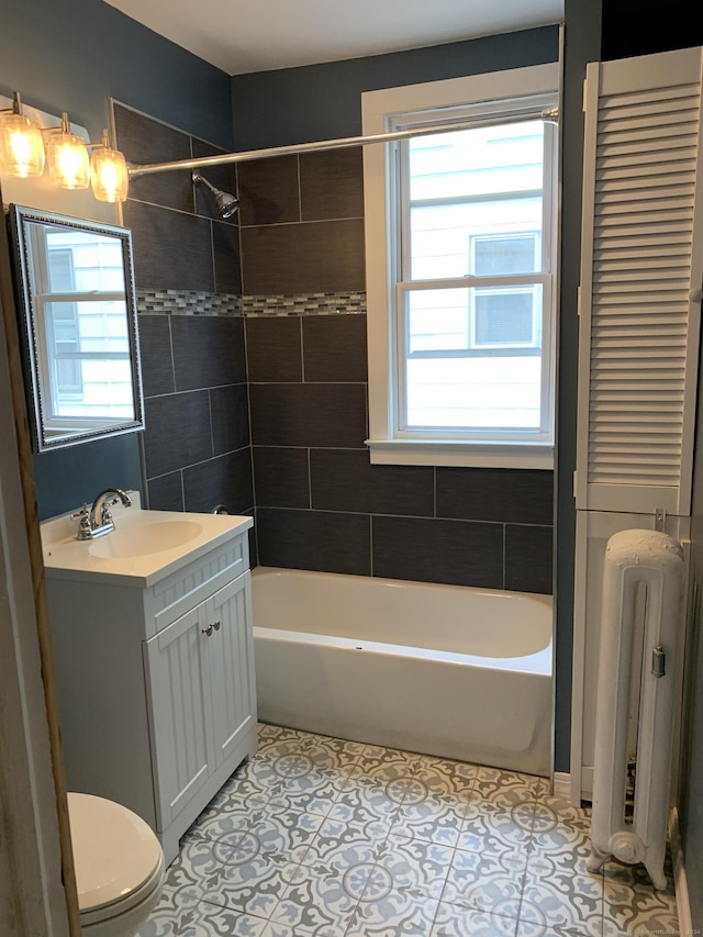 full bathroom with vanity, a healthy amount of sunlight, toilet, and radiator