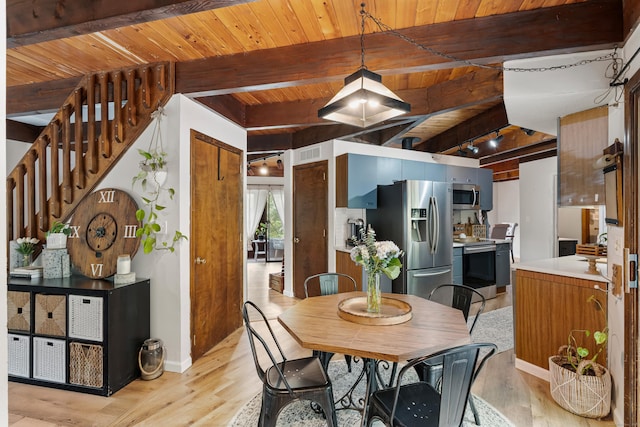 dining room featuring beamed ceiling, wood ceiling, and light hardwood / wood-style flooring