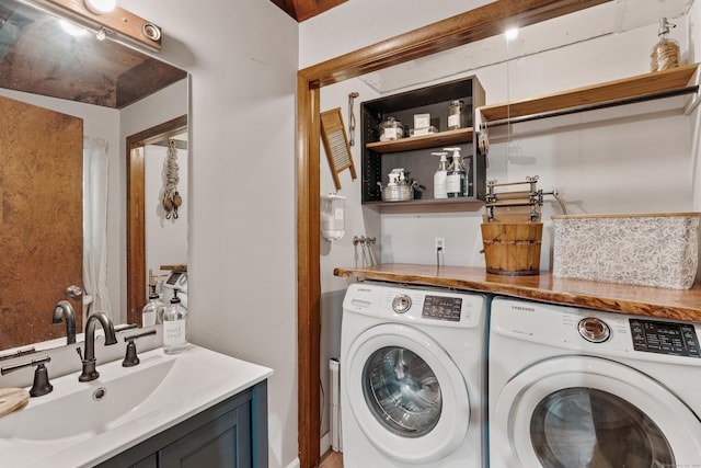 laundry room featuring washing machine and dryer and sink