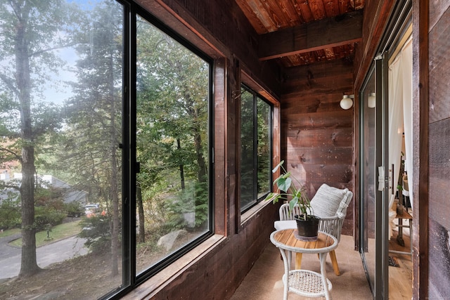 unfurnished sunroom featuring wood ceiling and a healthy amount of sunlight