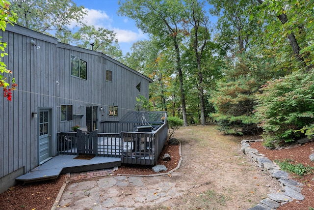 back of house with a wooden deck