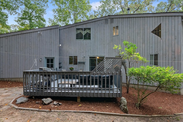 back of house featuring a wooden deck