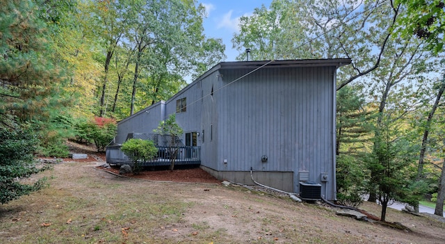 view of home's exterior with a deck and central air condition unit