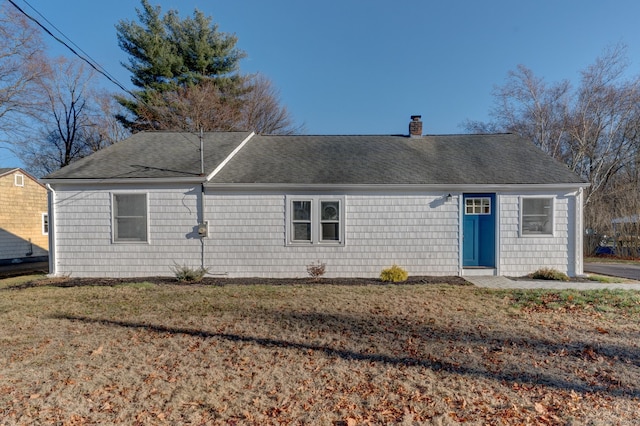 rear view of house with a lawn