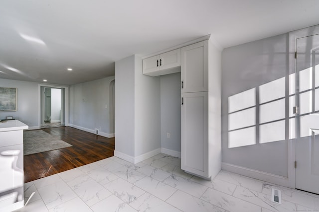 kitchen with white cabinets and light hardwood / wood-style flooring