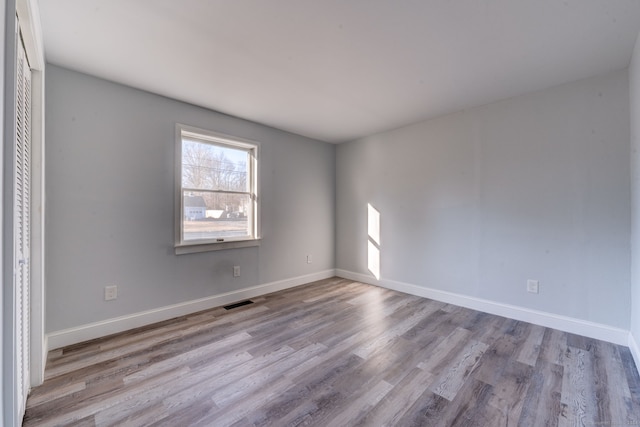 unfurnished room with light hardwood / wood-style flooring