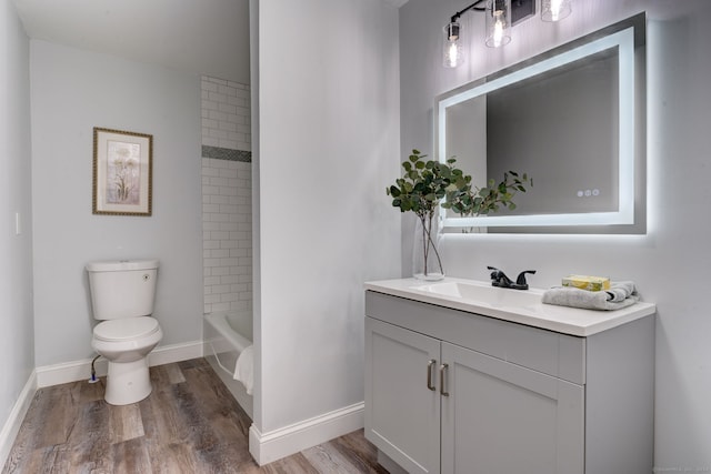 full bathroom with wood-type flooring, vanity, toilet, and tiled shower / bath