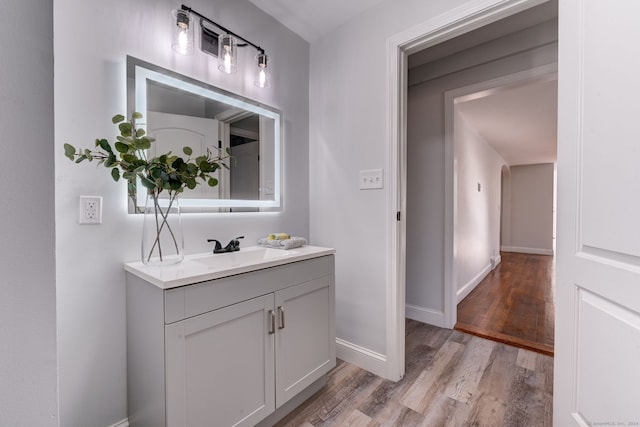 bathroom with hardwood / wood-style floors and vanity